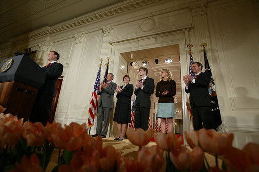 President George W. Bush, left, applauds as he listens to newly confirmed U.S. Supreme Court Justice Samuel Alito address an audience, Tuesday, Feb. 1, 2006 in the East Room of the White House, prior to being sworn-in by U.S. Supreme Court Chief Justice John Roberts, right. President Bush stands with Alito's wife, Martha-Ann, their son, Phil and daughter, Laura. White House photo by Paul Morse