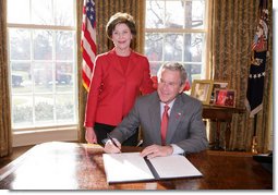 President George W. Bush is joined by Laura Bush, Wed. Feb. 1, 2006 in the Oval Office at the White House, as he signs a proclamation in honor of American Heart Month.  White House photo by Paul Morse
