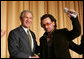 President George W. Bush shakes hands with Bono after the musician spoke Thursday morning, Feb. 2, 2006, during the National Prayer Breakfast. President Bush called the rock star a "doer" and a "good citizen of the world." White House photo by Paul Morse