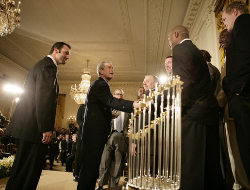 President George W. Bush welcomes Chicago White Sox players to the White House, Monday, Feb. 13, 2006 during an East Room ceremony to honor the 2005 World Series Champions. The World Series Trophy is seen foreground. White House photo by Eric Draper