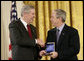 President George W. Bush presents a National Medal of Technology, Monday, Feb. 13, 2006 to Henry L. Nordoff, president, chairman and CEO of Gen-Probe Incorporated of San Diego, Calif., during ceremonies in the East Room of the White House. White House photo by Eric Draper