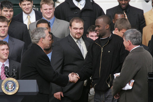 President George W. Bush welcomes University of Texas Longhorns star quarterback Vince Young to the White House, Tuesday, Feb. 14, 2006, during ceremonies to honor the 2005 NCAA Football Champions. White House photo by Paul Morse