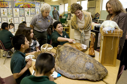 Laura Bush, listens to a student talk about Sea Turtles, Thursday, Feb. 16, 2006, as Fran Mainella, Director of the National Park Service, and Stella Summers, Teacher of the Gifted Science class, look on during a visit to Banyan Elementary School in Miami, FL, to support education about parks and the environment. White House photo by Shealah Craighead
