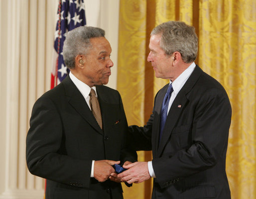 President George W. Bush congratulates Dr. Carl Anderson of Washington, upon receiving the President's Volunteer Service Award during a White House celebration of African American History Month. White House photo by Paul Morse