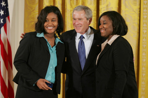 President George W. Bush congratulates Carrietha "Katie" Ball and her sister, Karl'Nequa Ball of Jackson, Miss., after awarding them the President's Volunteer Service Awards during a White House celebration of African American History Month. White House photo by Paul Morse