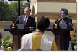 President George W. Bush smiles as he responds to a question Thursday, March 2, 2006, during a press availability with India's Prime Minister Manmohan Singh in the Mughal Garden at the Hyderabad House in New Delhi.  White House photo by Paul Morse