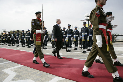 President George W. Bush is escorted by an honor guard as he reviews Pakistan troops at his official welcome to Aiwan-e-Sadr in Islamabad, Pakistan, Saturday, March 4, 2006. White House photo by Eric Draper