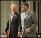 President George W. Bush and Pakistan President Pervez Musharraf walk together to their joint news conference at Aiwan-e-Sadr in Islamabad, Pakistan, Saturday, March 4, 2006. White House photo by Shealah Craighead