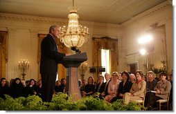 President George W. Bush joins in the celebration of International Women's Day at the White House Tuesday, March 7, 2006, as he thanks the female members of his audience for their leadership. "The struggle for women's right is a story of strong women willing to take the lead," the President told them and added, America's "a better place because of the leadership of women throughout our history."  White House photo by Shealah Craighead