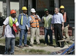 President George W. Bush talks with workers cleaning up the hurricane ravaged neighborhood of the lower 9th Ward of New Orleans, Wednesday, March 8, 2006, during a tour of New Orleans neighborhoods. White House photo by Eric Draper