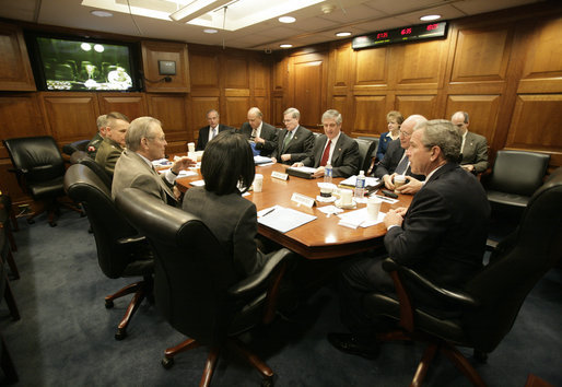 President George W. Bush meets with his National Security team in the White House Situation Room, Friday, March 10, 2006, on the latest developments in Iraq. At the table are Vice President Dick Cheney; Chief of Staff Andy Card; National Security Advisor Stephen Hadley; National Intelligence Director John Negroponte; Central Intelligence Agency Director Porter Goss; U.S. Army General John Abizaid; Chairman Joint Chiefs of Staff U.S. Marine General Peter Pace; Secretary of Defense Donald Rumsfeld and Secretary of State Condoleezza Rice. On screen are U.S. Ambassador to Iraq Zalmay Khalilzad, left, and U.S. Army General George Casey. Seated at far-right are White House Counsel Harriet Miers and Deputy National Security Advisor J. D. Crouch. White House photo by Eric Draper