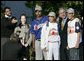 President George W. Bush poses for photographs with South American baseball players Tuesday, March 14, 2006, on the South Lawn of the White House. The players were guests at the arrival of Marine One after the President's trip to New York. The group is here on a State Department-funded International Sports Exchange centered around a shared passion of baseball and the inaugural World Baseball Classic. The players, from left, are: Geovanny Toval Monterrey, 17, from Nicaragua; Ronald Torreyes Solorzano, 14, from Venezuela; Bryan Guillen, 16, (in back) from Nicaragua, and Argerd Liendo Boada, 16, from Venezuela. White House photo by Eric Draper
