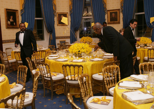White House butlers place the finishing touches on table settings and decorations, Thursday evening, March 23, 2006 in the Blue Room of the White House, for a Social Dinner hosted by President George W. Bush and Mrs. Laura Bush in honor of the 300th Birthday of Benjamin Franklin. White House photo by Shealah Craighead