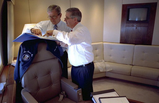 President George W. Bush confers with Chief of Staff Andrew Card aboard Air Force One en route to El Paso in this March 2002 file photo. Tuesday, March 28, 2006, the President announced the resignation of Secretary Card effective in April. White House photo by Eric Draper