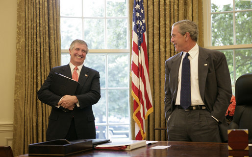 President George W. Bush shares a light moment with Chief of Staff Andrew Card in the Oval Office in this June 2005 file photo. Tuesday, March 28, 2006, the President announced Secretary Card's resignation effective in April. White House photo by Eric Draper