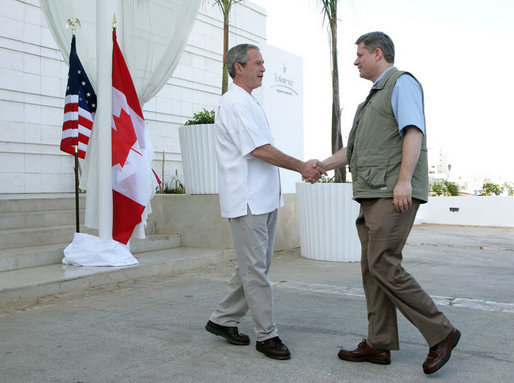 President George W. Bush shakes hands with Canadian Prime Minister Stephen Harper, Thursday, March 30, 2006 in Cancun, Mexico, in their first meeting since Harper was elected Prime Minister. President Bush is participating in a three-day summit with the leaders of Mexico and Canada. White House photo by Kimberlee Hewitt