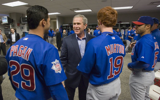 President George W. Bush talks with Cubs outfielders Angel Pagan, left, and Matt Murton before the opening game between the Cincinnati Reds and the Chicago Cubs in Cincinnati, Ohio, Monday, April 3, 2006. White House photo by Eric Draper