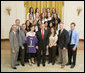 President George W. Bush stands with members of the University of Washington Women’s Volleyball Team Thursday, April 6, 2006, during a photo opportunity with the 2005 and 2006 NCAA Sports Champions. White House photo by Paul Morse