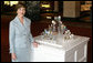 Mrs. Laura Bush poses for a photo next to the State Egg Display which exhibits a decorated egg from a select artist of each state Thursday, April 6, 2006, at the White House Visitor Center. This tradition has been going on since 1994, and each year the artists vote amongst themselves to select the artist to create the following year’s commemorative egg which is presented to the President and First Lady. White House photo by Shealah Craighead