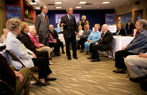 President George W. Bush and Senator Charles, Grassley, R-Iowa, talk with residents about Medicare prescription drug benefits at Wesley Acres Senior Center in Des Moines, Iowa, Tuesday, April 11, 2006. "Every senior is saving money, and that's what people have got to know.," said the President. "There is an easy way to find out how the program works, and that's to call 1-800-Medicare, or you can go on the computer systems at Medicare.gov." White House photo by Eric Draper