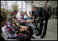 President George W. Bush and Senator Charles, Grassley, R-Iowa, greet residents at Wesley Acres Senior Center in Des Moines, Iowa, Tuesday, April 11, 2006. The President visited Iowa to talk about the Medicare prescription drug benefits. "Every senior is saving money, and that's what people have got to know," said the President. "There is an easy way to find out how the program works, and that's to call 1-800-Medicare, or you can go on the computer systems at Medicare.gov." White House photo by Eric Draper