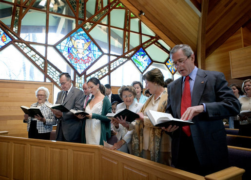 President George W. Bush and Mrs. Bush participate in an Easter service at the Evergreen Chapel at Camp David, Maryland, Sunday, April 16, 2006. Also pictured in front row, from right, are Jenna Welch, Barbara Bush, Former President George H. W. Bush and First Lady Barbara Bush. White House photo by Eric Draper