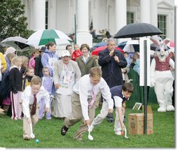 President George W. Bush is joined by Mrs. Laura Bush as he blows a whistle to start an Easter Egg Roll race on the South Lawn of the White House during the annual 2006 White House Easter Egg Roll, Monday, April 17, 2006. The first White House Easter Egg Roll was held in 1878.  White House photo by Kimberlee Hewitt