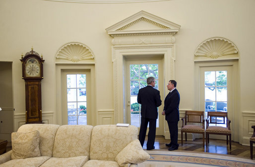 President George W. Bush and Prime Minister Fouad Siniora of Lebanon talk privately in the Oval Office Tuesday, April 18, 2006. White House photo by Eric Draper