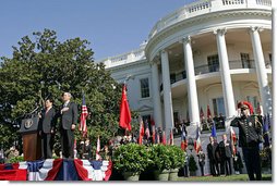 President George W. Bush and Chinese President Hu Jintao stand for the playing of the two countries' national anthems during the beginning of the South Lawn Arrival Ceremony Thursday, April 20, 2006.  White House photo by Shealah Craighead
