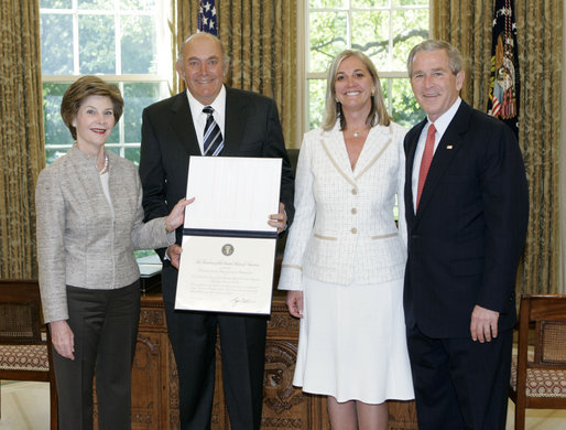 President George W. Bush and Mrs. Bush present the Preserve America award for private preservation to Arthur Tauck, Jr., Chairman of the Board, and his daughter Robin Tauck, President and CEO, both of Tauck World Discovery , in the Oval Office Monday, May 1, 2006. The company began a volunteer program for Yellowstone National Park in Montana, Idaho and Wyoming. White House photo by Eric Draper
