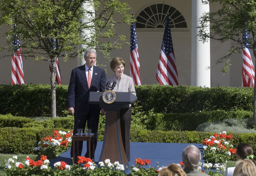Mrs. Laura Bush and President George W. Bush address guests in the Rose Garden during an event honoring the recipients of the Preserve America Presidential Awards May 1, 2006. White House photo by Kimberlee Hewitt