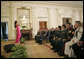 President George W. Bush and guests listen to artist Graciela Beltran perform during the White House celebration of Cinco De Mayo in the East Room Thursday, May 4, 2006. White House photo by Paul Morse