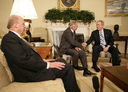 President George W. Bush shakes the hand of Porter Goss Friday, May 5, 2006, in the Oval Office after the Director of the Central Intelligence Agency announced his resignation. The President thanked him for his service and said of Director Goss, "He honors the proud history of the CIA." Looking on is Ambassador John Negroponte, Director of National Intelligence. White House photo by Eric Draper