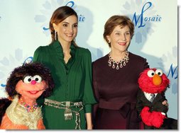 Mrs. Laura Bush stands with Her Majesty Queen Rania Al-Abdullah of Jordan and Sesame Street characters Khokha, left, and Elmo during a dinner celebrating the partnership between the Sesame Workshop and the Mosaic Foundation at the National Building Museum in Washington, D.C., Wednesday, May 9, 2006. Founded by the spouses of Arab Ambassadors to the United States, the Mosaic Foundation is dedicated to improving the lives of women and children. White House photo by Shealah Craighead