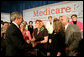 President George W. Bush greets audience members at the end of A Conversation on the Medicare Prescription Drug Benefit at the Asociacion Borinquena de Florida Central, Inc., in Orlando Wednesday, May 10, 2006. White House photo by Eric Draper