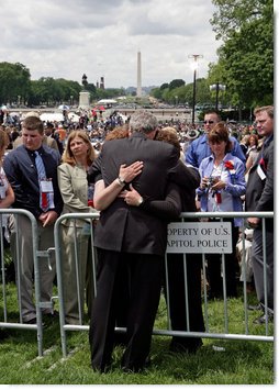 President George W. Bush embraces law enforcement family members during an emotional moment at the Annual Peace Officers' Memorial Service at the U. S. Capitol Monday, May 15, 2006. The service honors fallen federal, state and local law enforcement officers.  White House photo by Kimberlee Hewitt