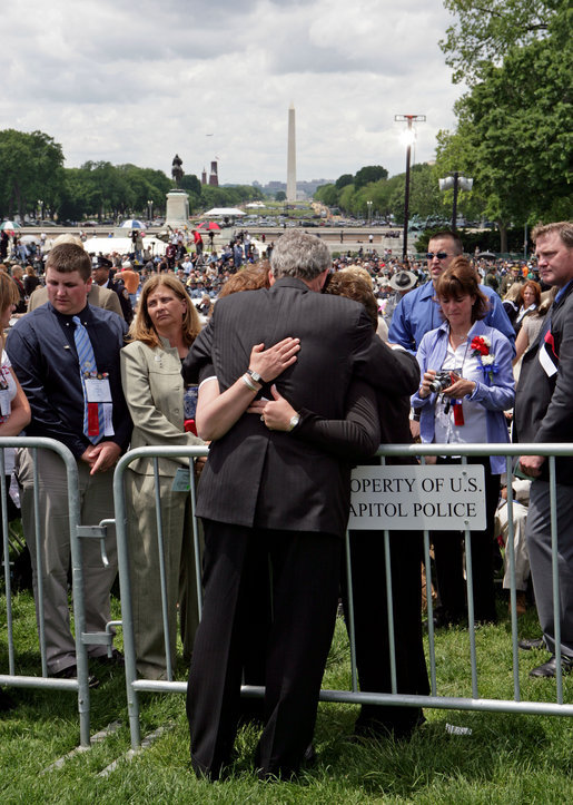 President George W. Bush embraces law enforcement family members during an emotional moment at the Annual Peace Officers' Memorial Service at the U. S. Capitol Monday, May 15, 2006. The service honors fallen federal, state and local law enforcement officers. White House photo by Kimberlee Hewitt