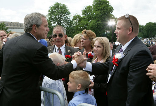 President George W. Bush speaks with law enforcement family members at the Annual Peace Officers' Memorial Service at the U. S. Capitol Monday, May 15, 2006. The service honors fallen federal, state and local law enforcement officers. White House photo by Kimberlee Hewitt