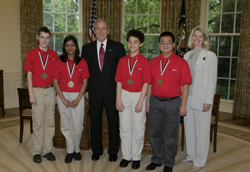 President George W. Bush stands with Top Team members of the MATHCOUNTS National Competition Monday, May 15, 2006, in the Oval Office of the White House. From left are: Jimmy Clark, 13, Falls Church, Va.; Divya Garg, 13, Annadale, Va.; President Bush; Brian Hamrick, 14, Annandale, Va.; Daniel Li, 14, of Fairfax, Va., and Barbara Burnett, Coach of the National Champion Team from Falls Church. White House photo by Paul Morse