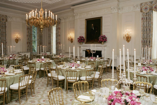 A portrait of President Abraham Lincoln is seen in the State Dining Room of the White House, as tables are set and decorated Tuesday, May 16, 2006, for the official dinner to honor Australian Prime Minister John Howard and his wife Janette Howard. White House photo by Shealah Craighead