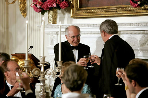 President George W. Bush and Prime Minister John Howard of Australia exchange toasts during an official dinner in the State Dining Room Tuesday, May 16, 2006. White House photo by Paul Morse
