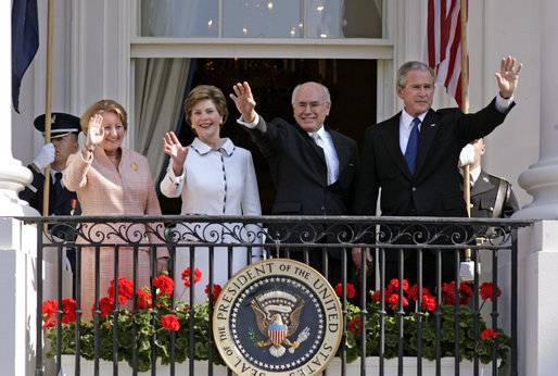President George W. Bush, Prime Minister John Howard, Mrs. Laura Bush and Mrs. Janette Howard wave from the South Portico of the White House during the State Arrival Ceremony on the South Lawn Tuesday, May 16, 2006. White House photo by Paul Morse