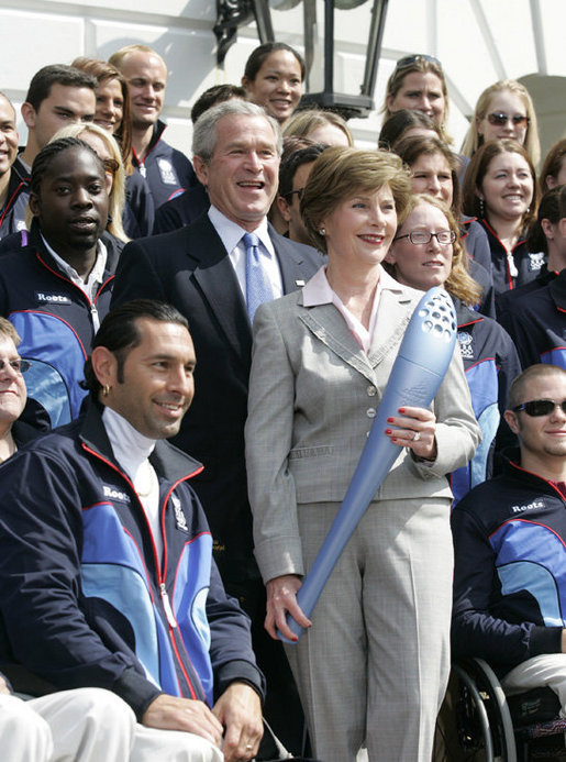 President George W. Bush and Laura Bush, seen holding an Olympic torch, pose with the 2006 U.S. Winter Olympic and Paralympic teams during a congratulatory ceremony held on the South Lawn at the White House Wednesday, May 17, 2006. White House photo by Eric Draper