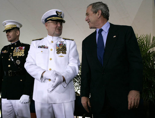 President George W. Bush smiles as he talks with Admiral Thad Allen, Commandant of the U.S. Coast Guard, on stage at Fort Lesley J. McNair in Washington D.C., during a Change of Command Ceremony Thursday, May 25, 2006. White House photo by Eric Draper
