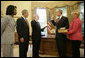 President George W. Bush is joined by Secretary of State Condoleezza Rice as Idaho Gov. Dirk Kempthorne is sworn into office as Secretary of the Interior by Chief of Staff Josh Bolten Friday, May 26, 2006. Mrs. Patricia Kempthorne holds the Kempthorne family Bible for the ceremony that was held in the Oval Office of the White House. White House photo by Eric Draper