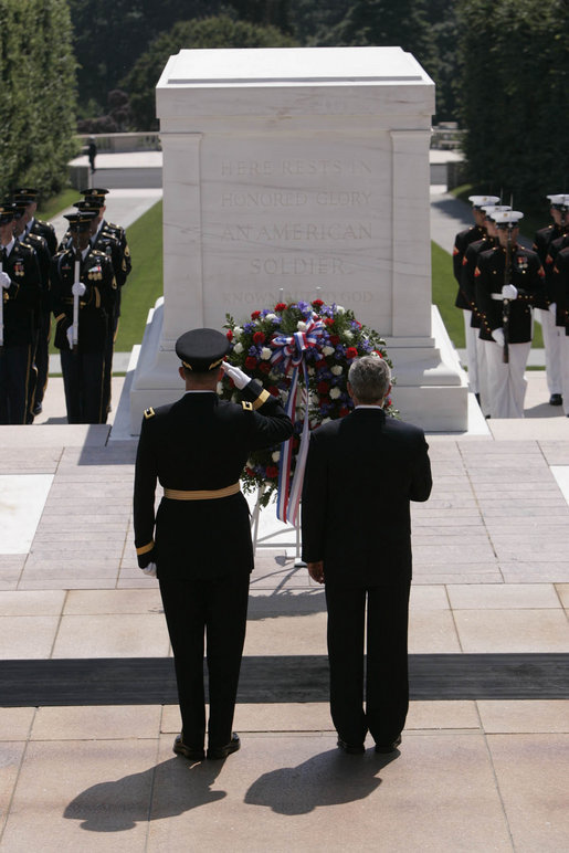 President George W. Bush stands with U.S. Army Major General Guy Swan for a moment of silence during the Memorial Day wreath laying ceremony at the Arlington National Cemetery Tomb of the Unknowns in Arlington, Va., Monday, May 29, 2006. White House photo by Paul Morse
