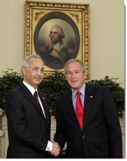 President George W. Bush exchanges handshakes with Samir Sumaidaie, Iraq's Ambassador to the United States, after receiving his credentials during an Oval Office ceremony Tuesday, May 30, 2006. Ambassador Sumaidaie is the first ambassador of a freely-elected, democratic Iraqi Government in decades.  White House photo by Paul Morse