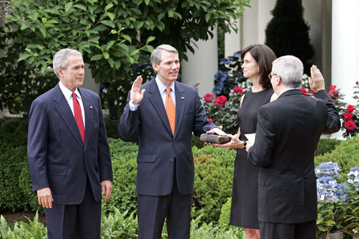 President George W. Bush attends the swearing-in ceremony of Rob Portman as the Director of the Office of Management and Budget in the Rose Garden Friday, June 2, 2006. Director Portman's wife Jane Portman hold the bible as White House Chief of Staff Joshua Bolten administers the oath. "The OMB Director is a critical member of my Cabinet," said the President. He plays a vital role in every aspect of my administration's agenda, from securing the homeland, to winning the war on terror, to growing our economy and creating jobs." White House photo by Eric Draper