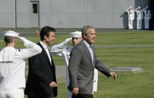 President George W. Bush escorts Prime Minister Anders Fogh Rasmussen of Denmark pass a U.S. Navy Honor Guard at Camp David Friday, June 9, 2006. Prime Minister Rasmussen and members of his family are visiting Camp David as guests of President Bush and Mrs. Laura Bush. White House photo by Eric Draper
