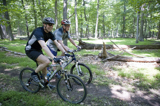 President George W. Bush and Prime Minister Anders Fogh Rasmussen of Denmark navigate a path at Camp David Friday, June 9, 2006. White House photo by Eric Draper